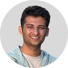 DishankJ220 Hippocratic AI Hippocratic AI Portrait of a smiling man with short dark hair wearing a light blue jacket against a gray background circular crop